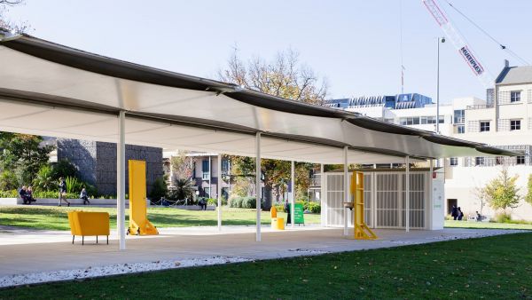 Mpavilion building with yellow furniture inside