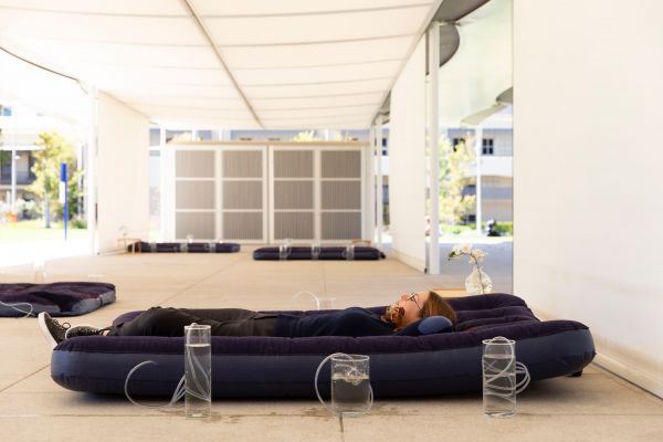 A woman sleeps on a blue inflatable bed